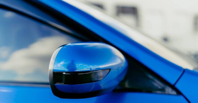 Close-up photo of a car window on a blue car.