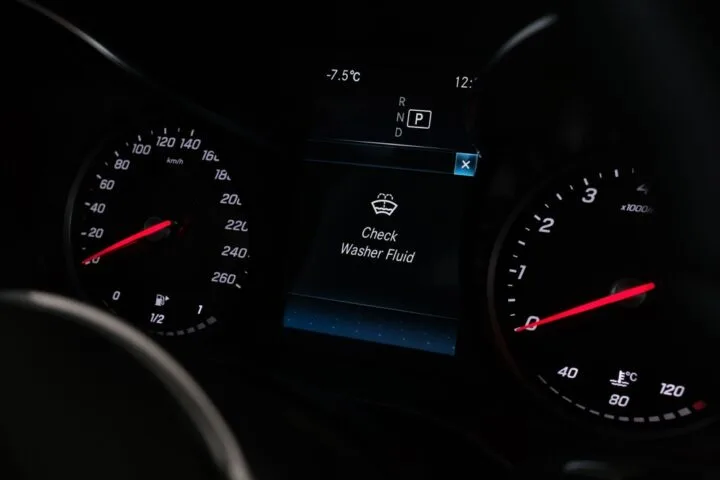Check washer fluid warning sign in the car dashboard.