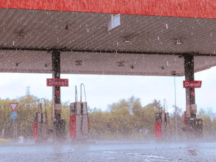 A photo of a gas station in a heavy rainfall.