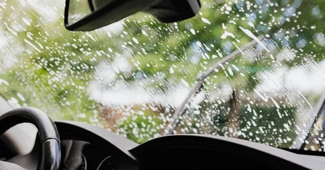 A car windshield with soap bubbles on it.