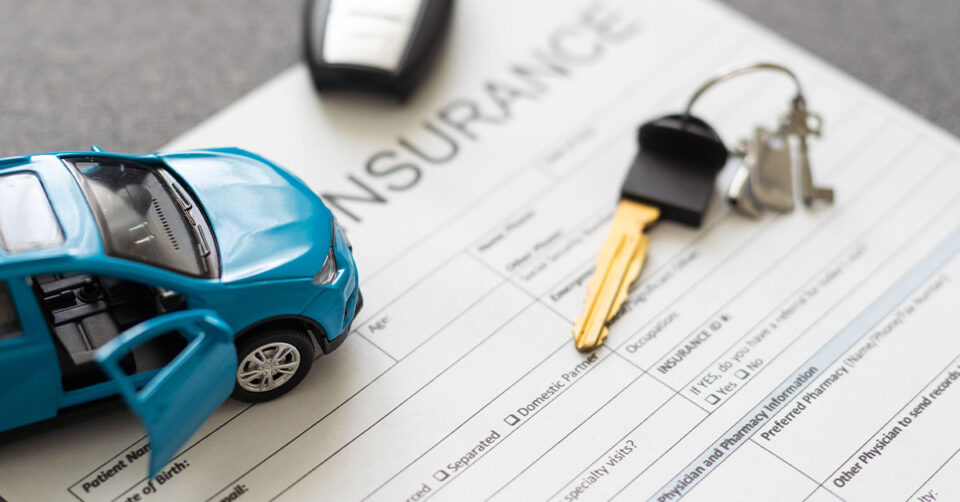 Car insurance paperwork with car keys