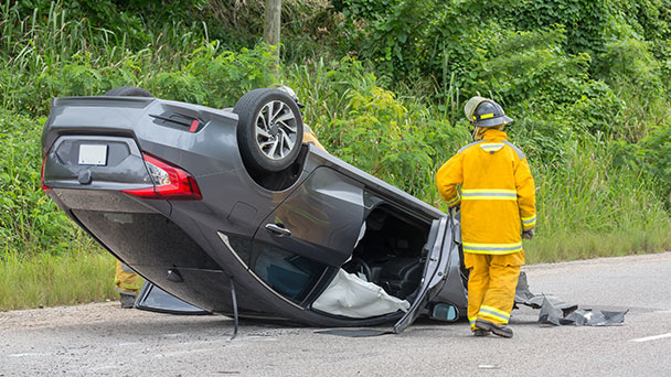 Car that has rolled on its roof during an accident. Airbags are inflated.