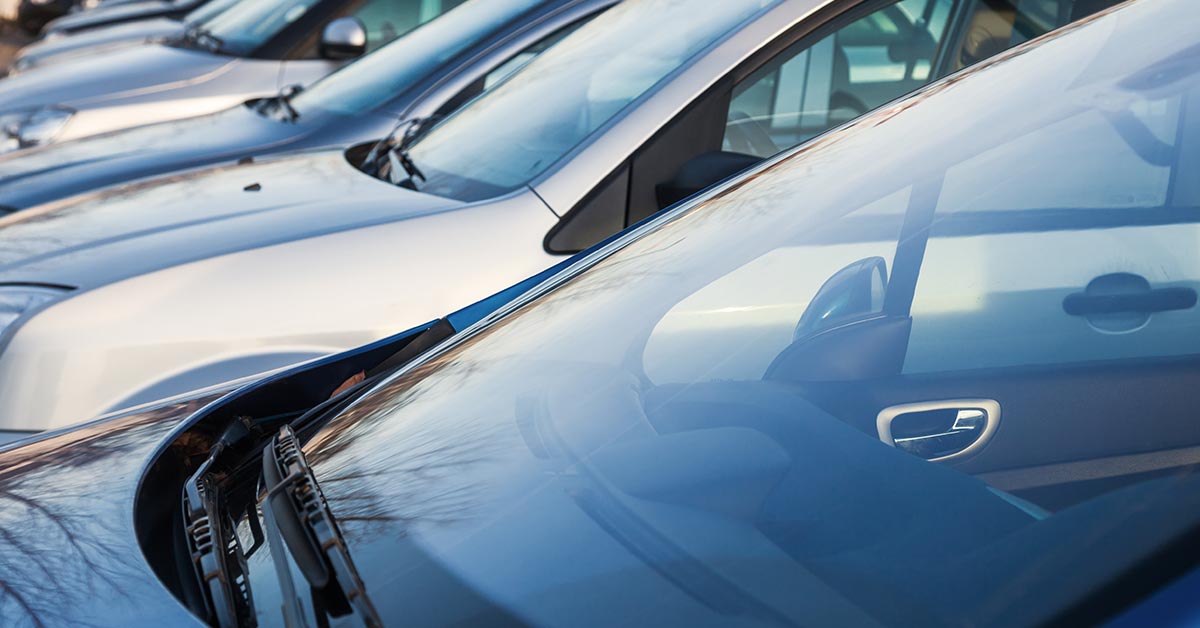 Row of cars with a close up view of the windscreen glass.