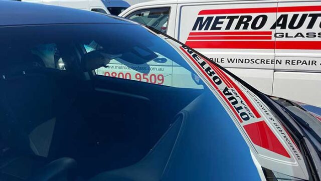 Newly installed windscreen glass with Metro Auto Glass van in background