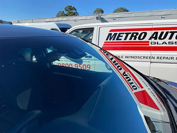 Newly installed windscreen glass with Metro Auto Glass van in background